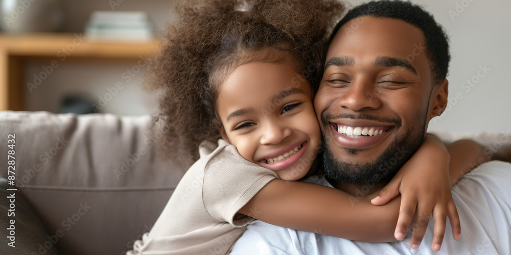 A father and daughter embracing warmly on a sofa at home, enjoying precious moments of love and bonding. A father and daughter embracing warmly on a sofa at home, enjoying precious moments of love and bonding.