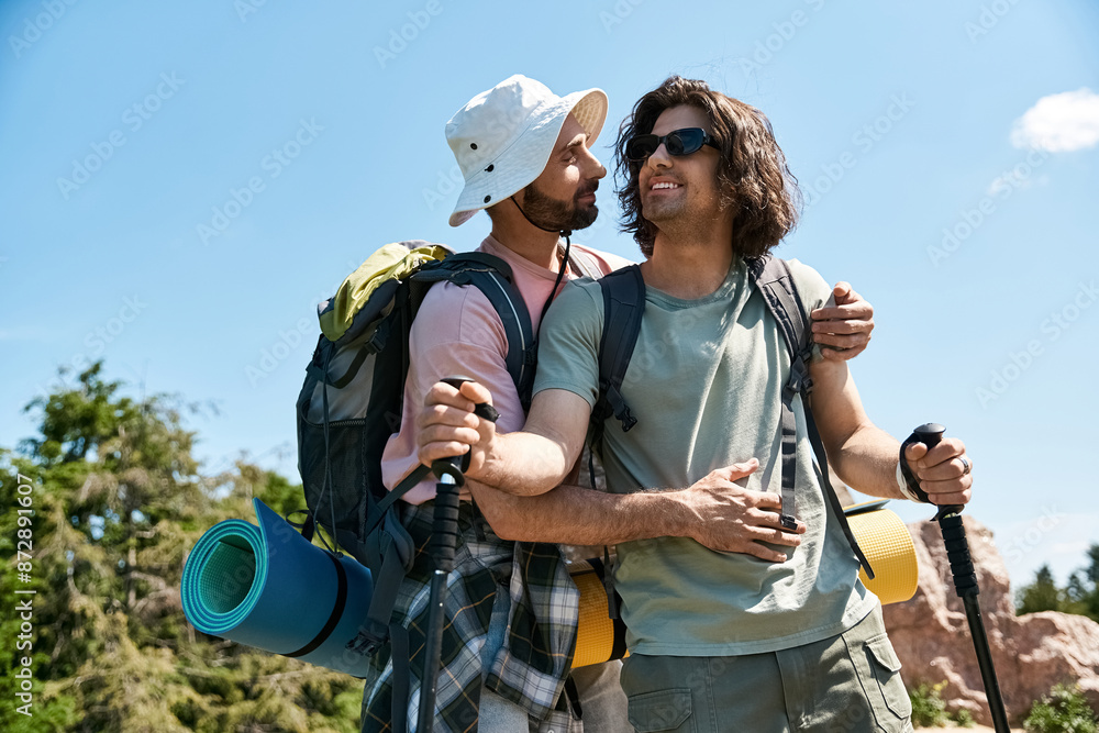 Fototapeta premium A young gay couple enjoys a summer hiking trip, sharing a loving embrace amidst beautiful natural scenery.