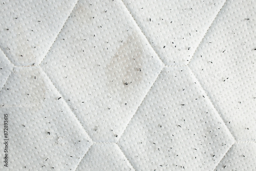 Used mattress close up background with stains and black lint