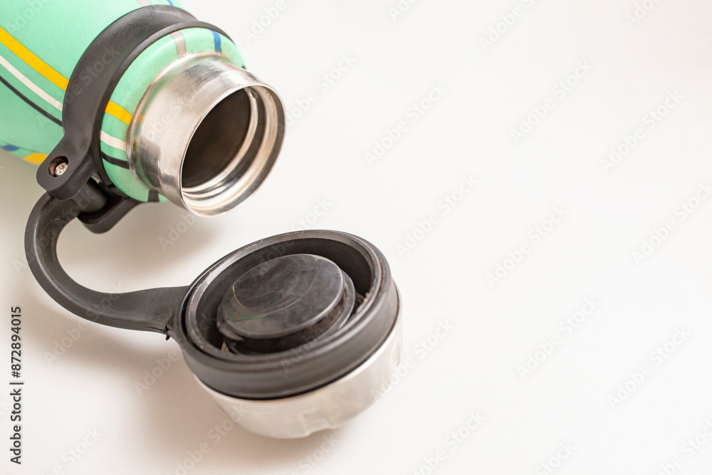 Plastic cap of a  Thermos flask isolated on white background, soft focus close up
