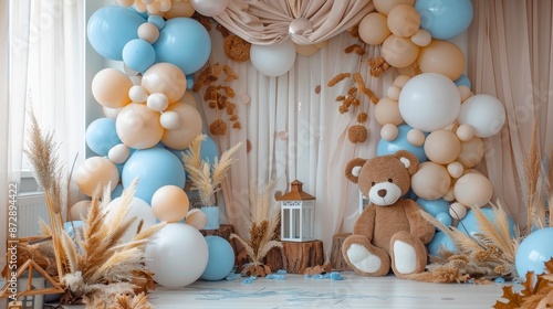 Beige, brown, and blue balloons backdrop, arch with bears. Photo-wall for celebration baptism or birthday party. Trendy autumn decor with dry leaves.