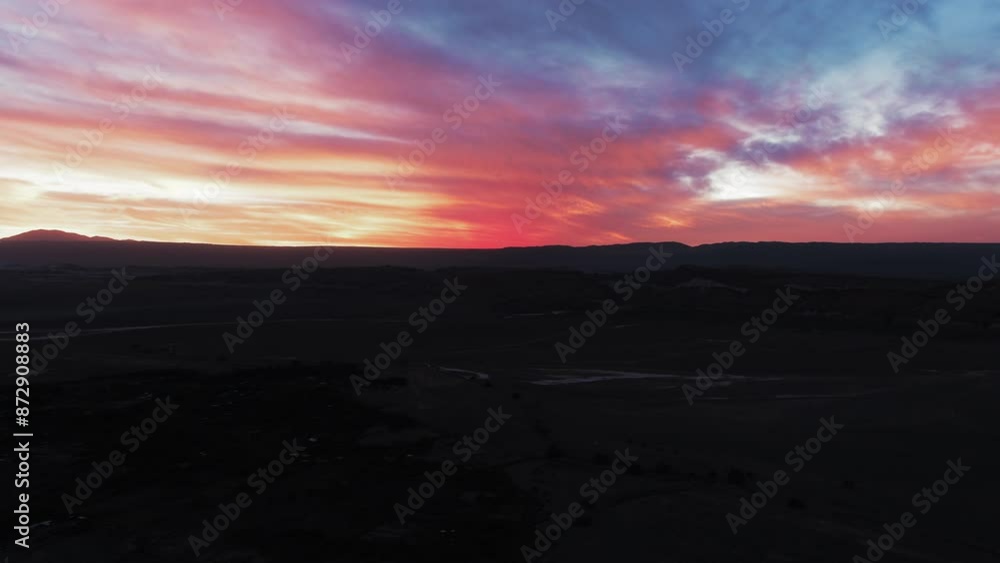 Aerial Silhouette Of Tranquil Rock Formations, Drone Flying Backwards Over Semi Arid Desert Landscape At Sunset - Atacama Desert, Chile Aerial Silhouette Of Tranquil Rock Formations, Drone Flying Backwards Over Semi Arid Desert Landscape At Sunset - Atacama Desert, Chile