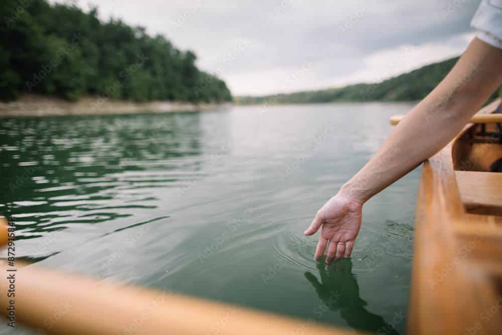 Fototapeta premium Close-up of woman hand touching a water surface 