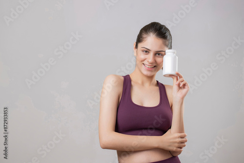 Close Up Of An Attractive Woman Holding A White Tablet Bottle