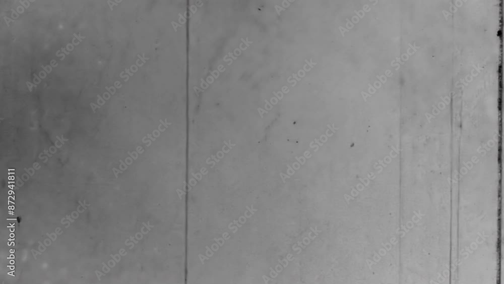 Old black and white scratches noise on film backdrop. Natural, real cinematic loader movie reel. Countdown loader overlay nostalgic wallpaper. Vintage archive transition. Archival retro 1960s texture