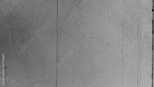 Old black and white scratches noise on film backdrop. Natural, real cinematic loader movie reel. Countdown loader overlay nostalgic wallpaper. Vintage archive transition. Archival retro 1960s texture