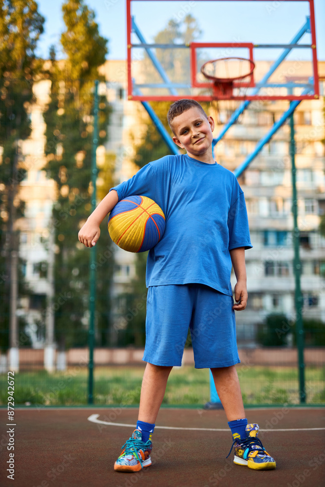Portrait of a boy with a basketball on a basketball court. Portrait of a boy with a basketball on a basketball court.