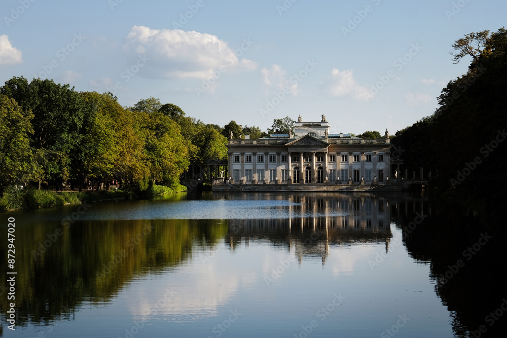 Sunset over the Palace Łazienki or Palace of the Water (Palace on the Isle) at Lazienki park in Warsaw, Poland Sunset over the Palace Łazienki or Palace of the Water (Palace on the Isle) at Lazienki park in Warsaw, Poland