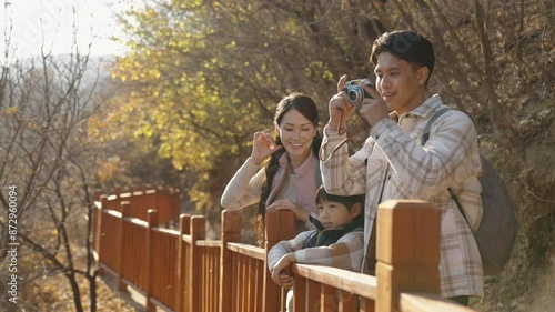 Cheerful young family enjoying the beautiful natural scenery