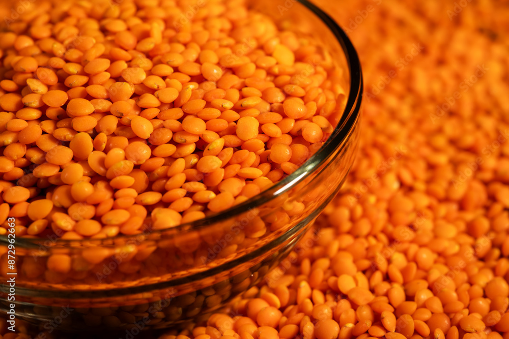 Red lentils in bowl on a lentils background Red lentils in bowl on a lentils background