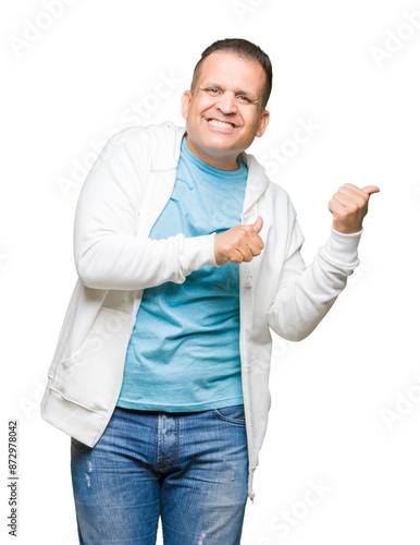 Middle age arab man wearing sweatshirt over isolated background Pointing to the back behind with hand and thumbs up, smiling confident