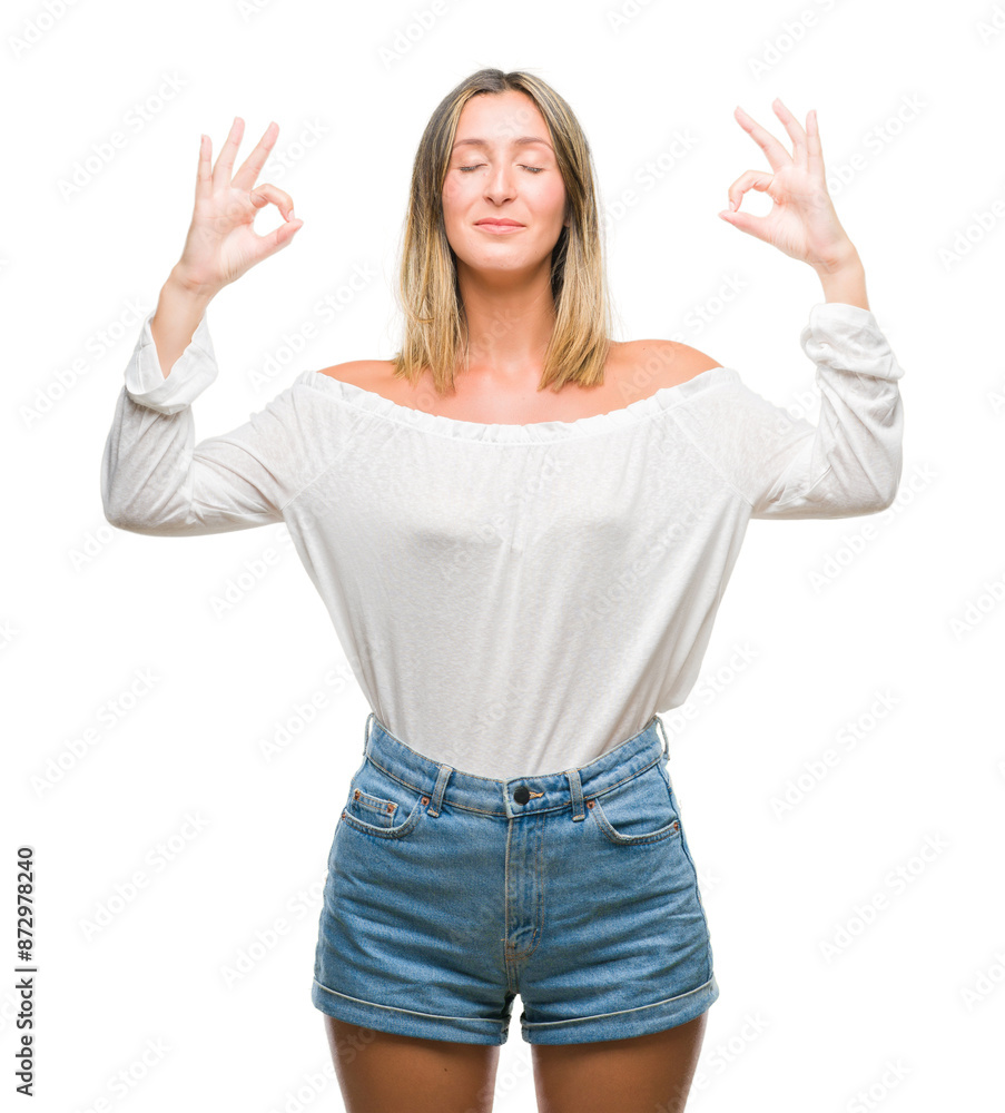 Young beautiful woman over isolated background relax and smiling with eyes closed doing meditation gesture with fingers. Yoga concept. Young beautiful woman over isolated background relax and smiling with eyes closed doing meditation gesture with fingers. Yoga concept.