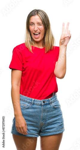 Young beautiful woman over isolated background smiling with happy face winking at the camera doing victory sign. Number two.