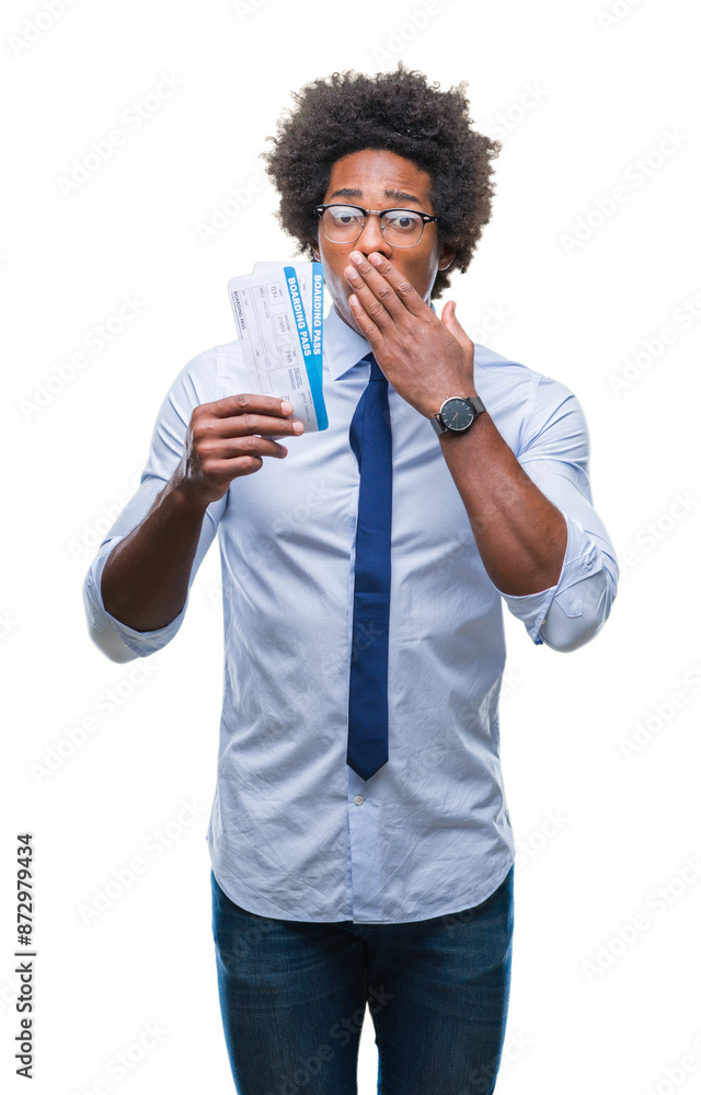 Afro american man holding boarding pass over isolated background cover mouth with hand shocked with shame for mistake, expression of fear, scared in silence, secret concept Afro american man holding boarding pass over isolated background cover mouth with hand shocked with shame for mistake, expression of fear, scared in silence, secret concept