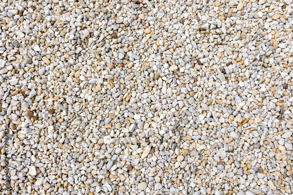 An assortment of diverse, small to medium-sized rocks and pebbles in a range of colors including grays, whites, and beiges, creating a natural and textured surface pattern. An assortment of diverse, small to medium-sized rocks and pebbles in a range of colors including grays, whites, and beiges, creating a natural and textured surface pattern.