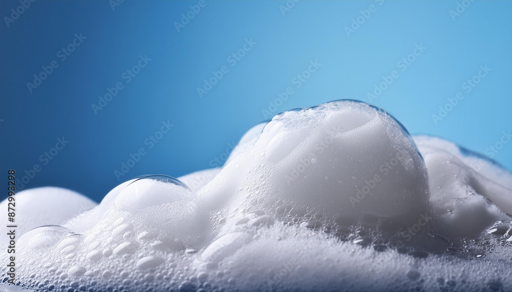 Soap foam texture on blue background. Shampoo bubbles. Hygiene, bath and spa care concept. Soap foam texture on blue background. Shampoo bubbles. Hygiene, bath and spa care concept.