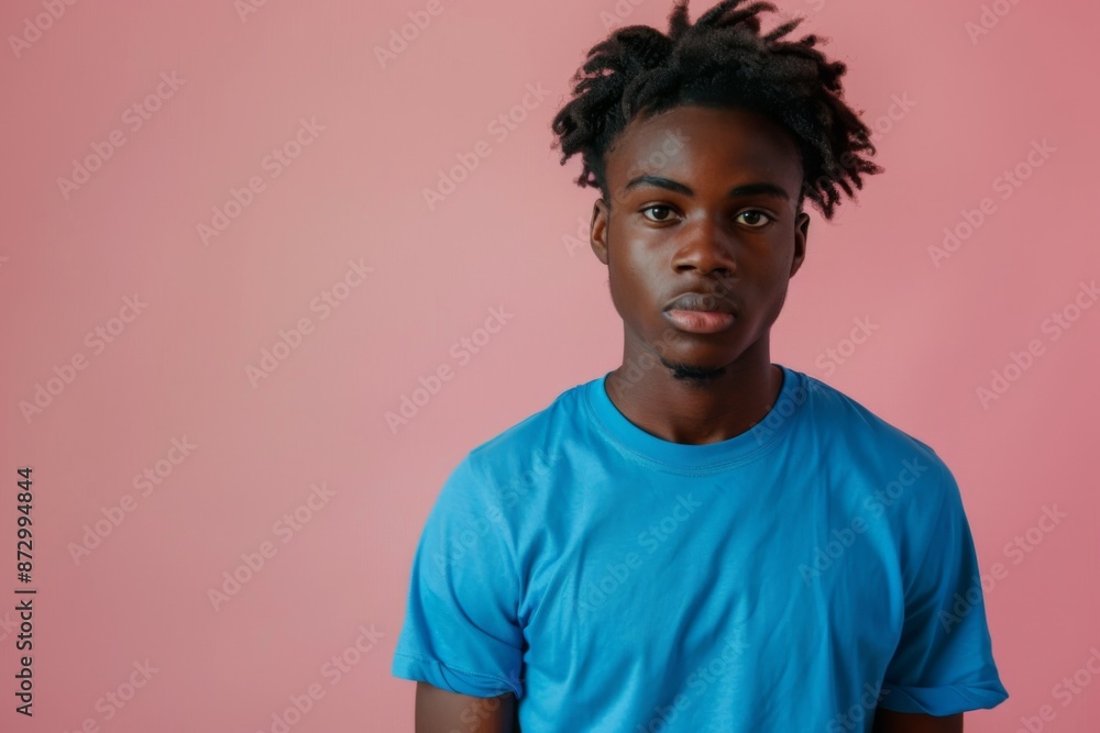 Young Man Standing Against Pink Background Young Man Standing Against Pink Background