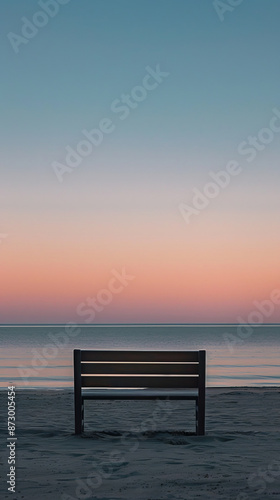 Bench on beach at dawn, serene early morning sky. Tranquil solitude and nature appreciation concept