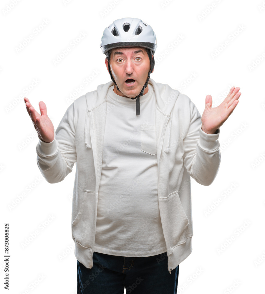 Handsome senior cyclist man wearing bike helmet over isolated background very happy and excited, winner expression celebrating victory screaming with big smile and raised hands Handsome senior cyclist man wearing bike helmet over isolated background very happy and excited, winner expression celebrating victory screaming with big smile and raised hands