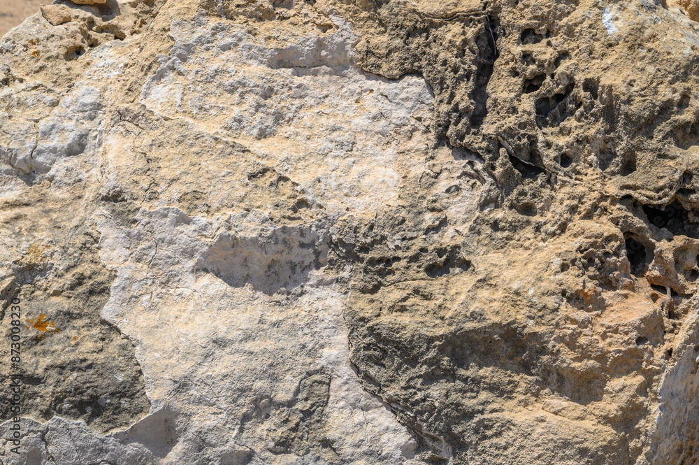 Neutral sandstone (sand stone) texture, seamless repeating pattern suitable for a wallpaper or background