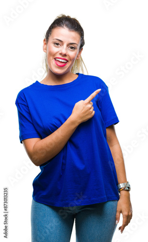 Young beautiful woman wearing casual blue t-shirt over isolated background cheerful with a smile of face pointing with hand and finger up to the side with happy and natural expression on face. photo