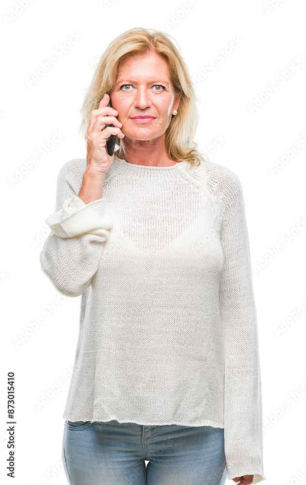 Middle age blonde woman talking on smartphone over isolated background with a confident expression on smart face thinking serious Middle age blonde woman talking on smartphone over isolated background with a confident expression on smart face thinking serious