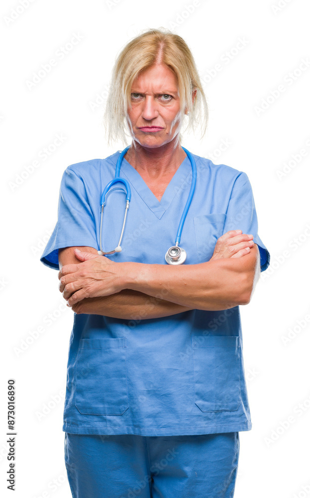 Middle age blonde nurse surgeon doctor woman over isolated background skeptic and nervous, disapproving expression on face with crossed arms. Negative person. Middle age blonde nurse surgeon doctor woman over isolated background skeptic and nervous, disapproving expression on face with crossed arms. Negative person.
