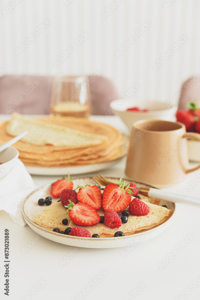 French homemade pancake crepes with berries. Summer breakfast.
