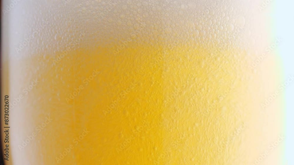 Beer pours into a glass, forming effervescent bubbles and a frothy head. Detail shot, macro. beer capturing the spirit of octoberfest celebration . alcoholic drink Beer pours into a glass, forming effervescent bubbles and a frothy head. Detail shot, macro. beer capturing the spirit of octoberfest celebration . alcoholic drink