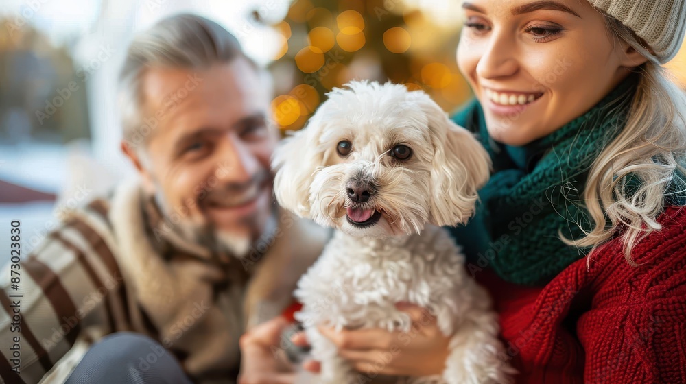 A gleeful man and a woman holding their fluffy white dog, capturing a heartwarming moment surrounded by Christmas decorations, symbolizing familial love and happiness. A gleeful man and a woman holding their fluffy white dog, capturing a heartwarming moment surrounded by Christmas decorations, symbolizing familial love and happiness.