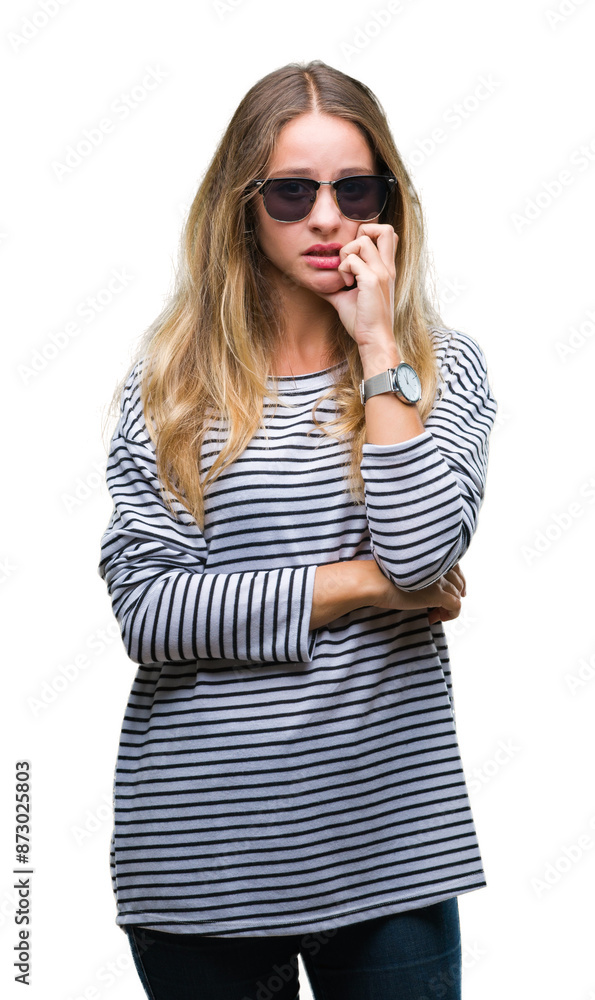 Young beautiful blonde woman wearing sunglasses over isolated background looking stressed and nervous with hands on mouth biting nails. Anxiety problem. Young beautiful blonde woman wearing sunglasses over isolated background looking stressed and nervous with hands on mouth biting nails. Anxiety problem.