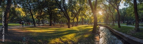 Sunset Over a River in a Green Park With Fall Foliage