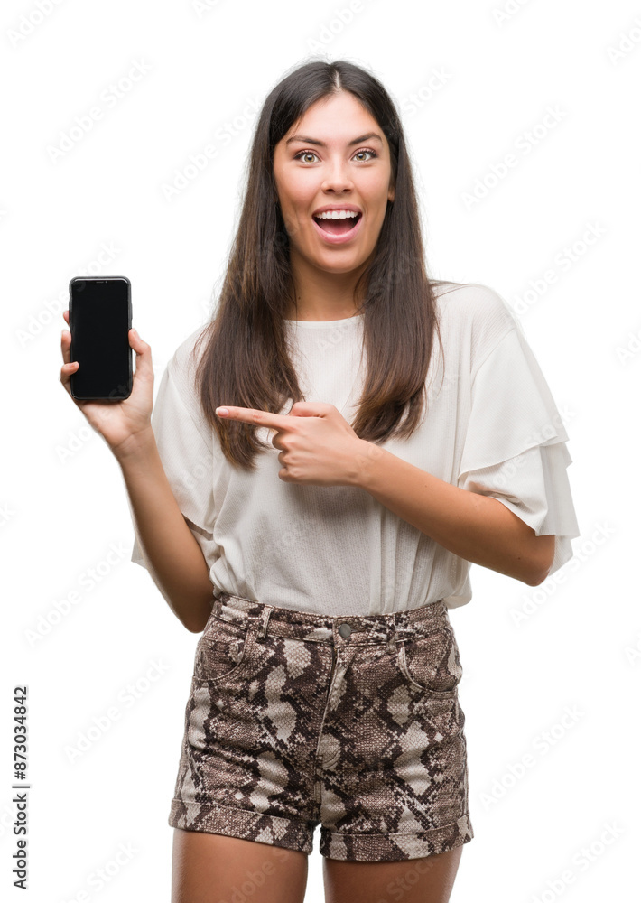 Young beautiful hispanic using smartphone very happy pointing with hand and finger Young beautiful hispanic using smartphone very happy pointing with hand and finger