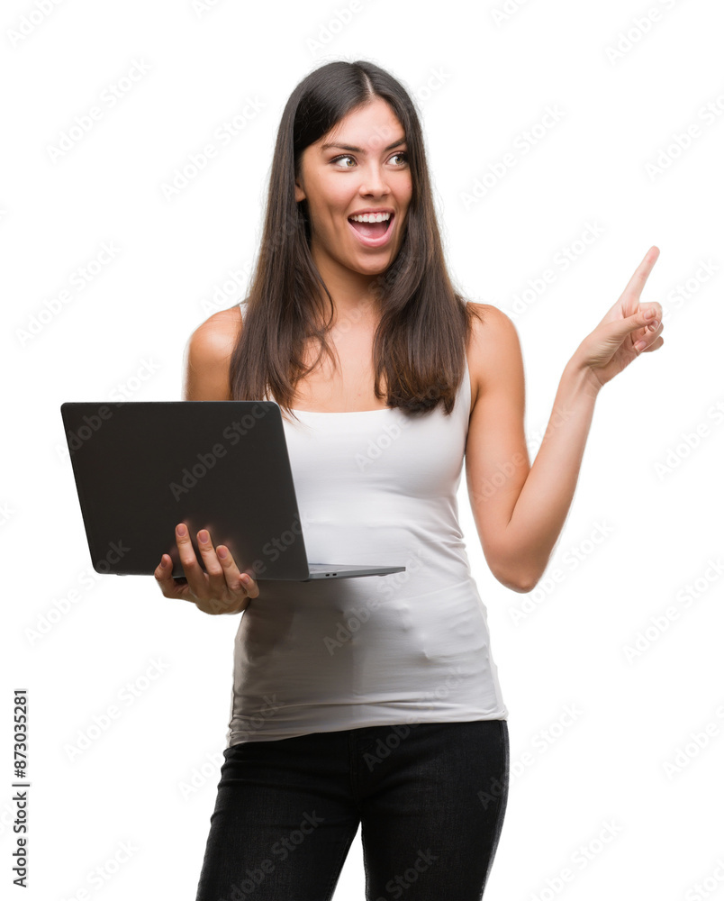 Young hispanic woman using computer laptop very happy pointing with hand and finger to the side Young hispanic woman using computer laptop very happy pointing with hand and finger to the side