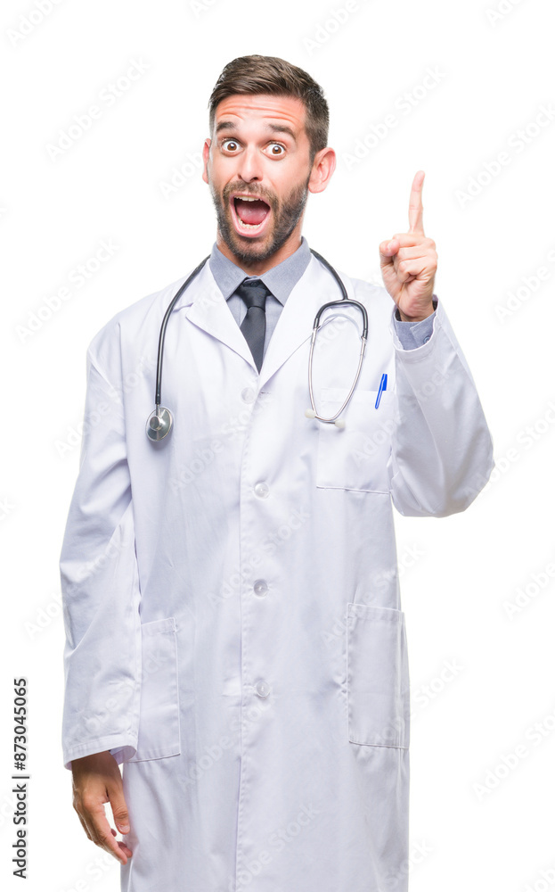 Young handsome doctor man over isolated background pointing finger up with successful idea. Exited and happy. Number one. Young handsome doctor man over isolated background pointing finger up with successful idea. Exited and happy. Number one.