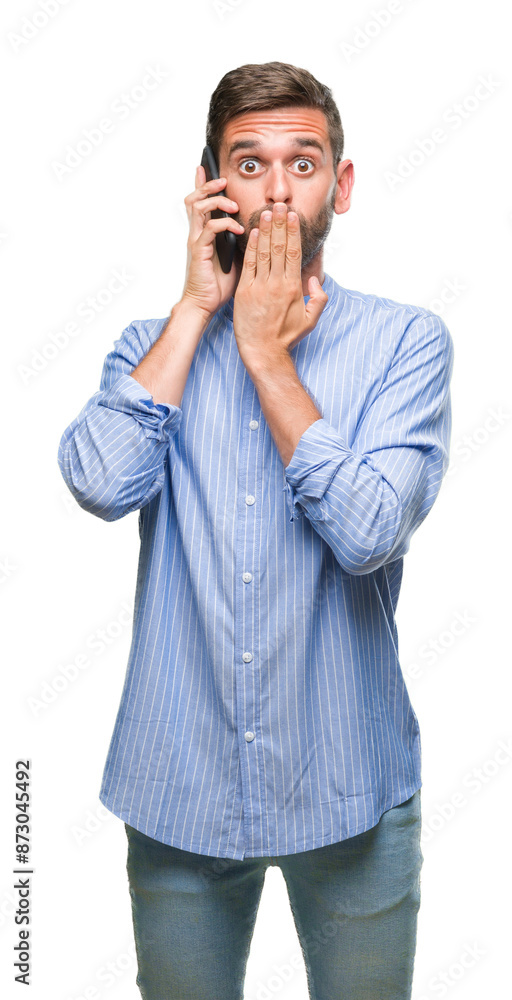Young handsome man speaking on the phone over isolated background cover mouth with hand shocked with shame for mistake, expression of fear, scared in silence, secret concept Young handsome man speaking on the phone over isolated background cover mouth with hand shocked with shame for mistake, expression of fear, scared in silence, secret concept