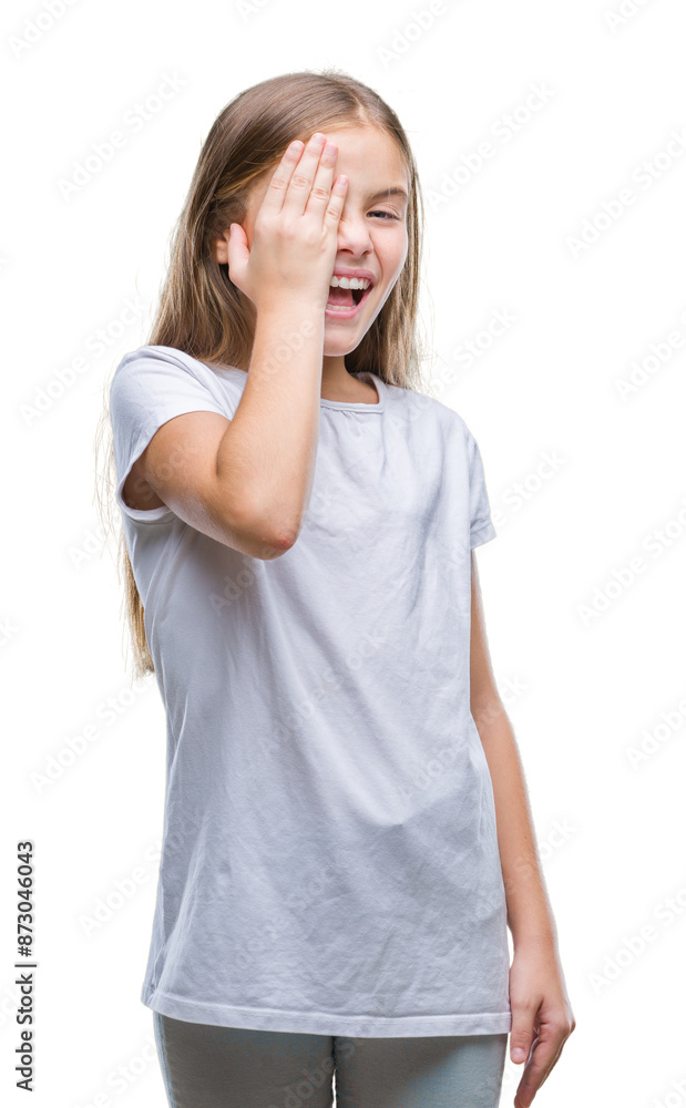 Young beautiful girl over isolated background covering one eye with hand with confident smile on face and surprise emotion. Young beautiful girl over isolated background covering one eye with hand with confident smile on face and surprise emotion.