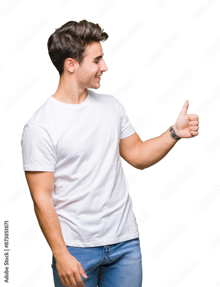 Young handsome man wearing white t-shirt over isolated background Looking proud, smiling doing thumbs up gesture to the side Young handsome man wearing white t-shirt over isolated background Looking proud, smiling doing thumbs up gesture to the side