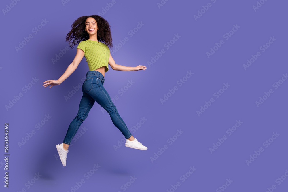 Obraz premium Full size photo of pretty teen girl jump running wear trendy green outfit isolated on purple color background
