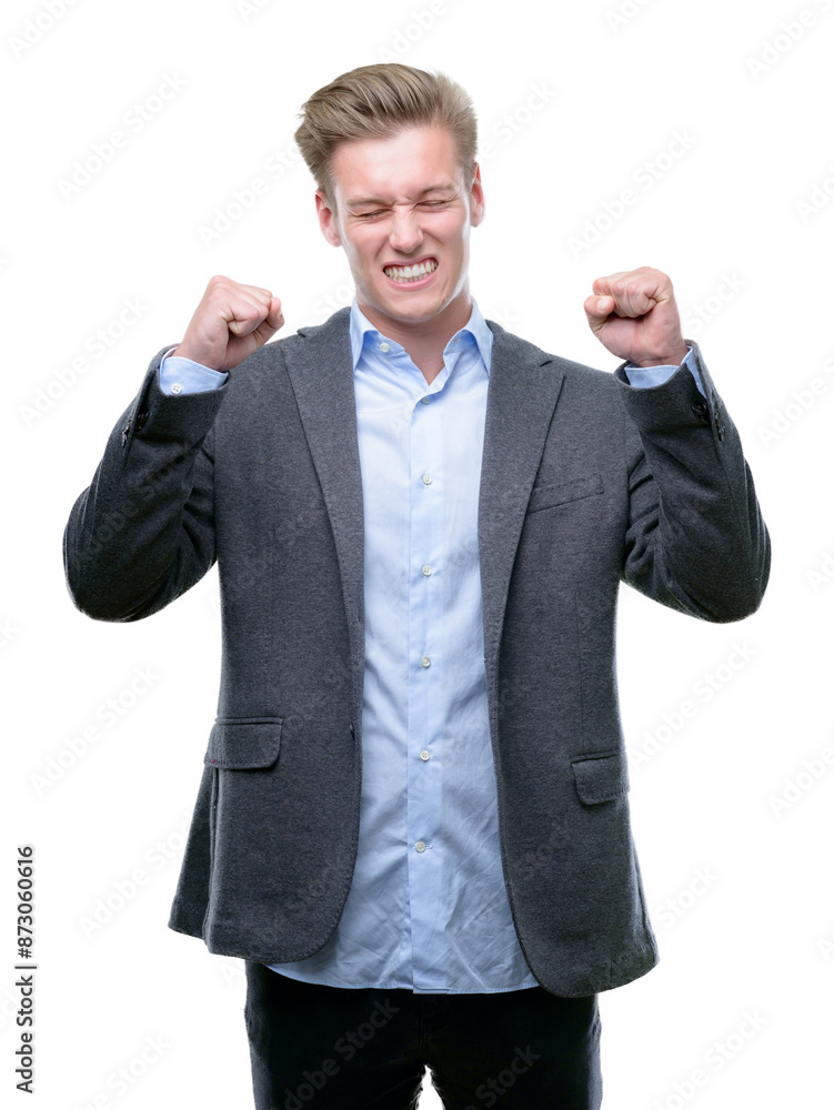 Young handsome blond business man excited for success with arms raised celebrating victory smiling. Winner concept. Young handsome blond business man excited for success with arms raised celebrating victory smiling. Winner concept.