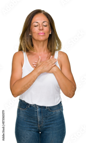 Beautiful middle age casual adult woman over isolated background smiling with hands on chest with closed eyes and grateful gesture on face. Health concept.