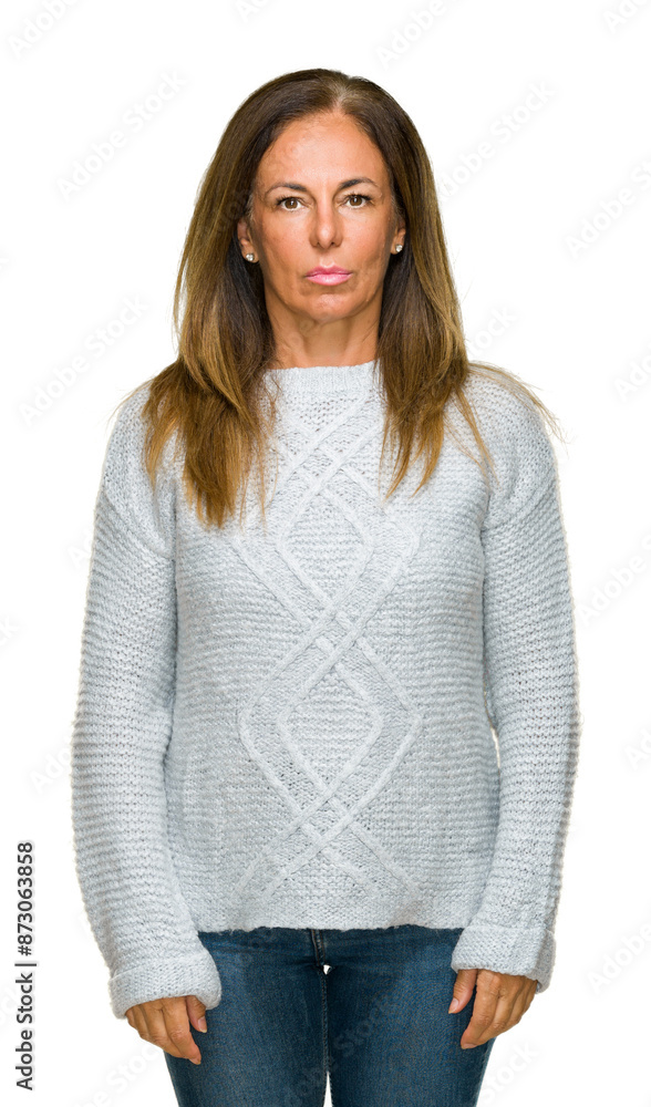 Beautiful middle age adult woman wearing winter sweater over isolated background with serious expression on face. Simple and natural looking at the camera. Beautiful middle age adult woman wearing winter sweater over isolated background with serious expression on face. Simple and natural looking at the camera.