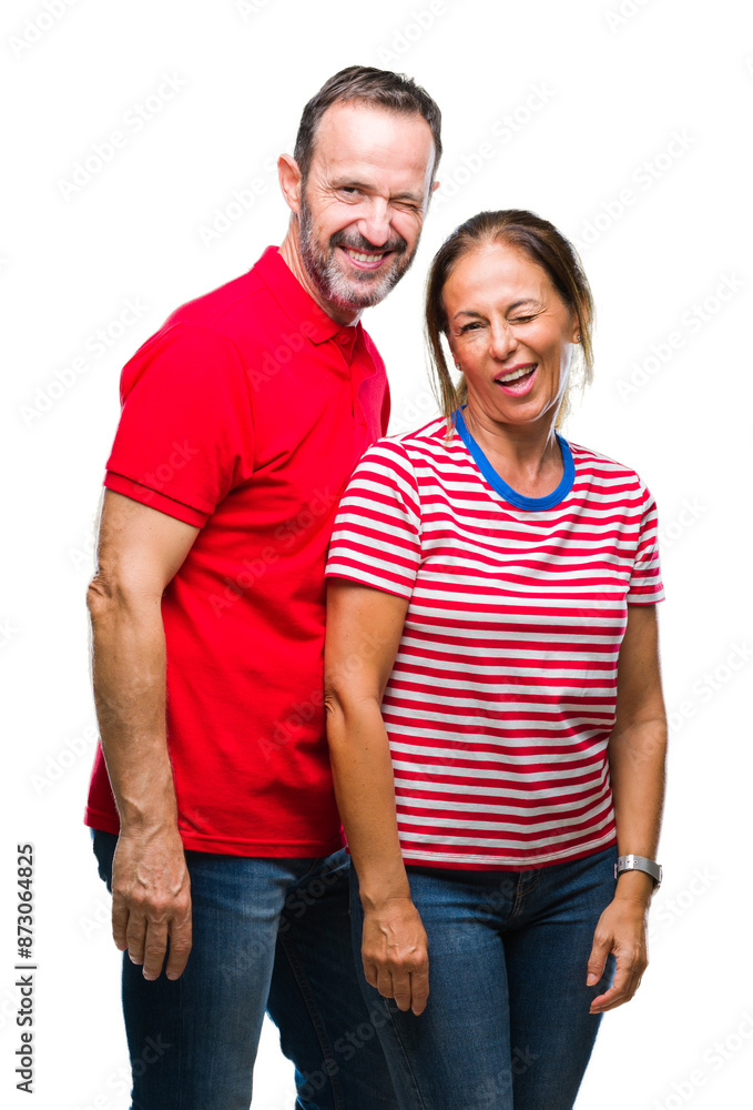 Middle age hispanic couple in love over isolated background winking looking at the camera with sexy expression, cheerful and happy face. Middle age hispanic couple in love over isolated background winking looking at the camera with sexy expression, cheerful and happy face.