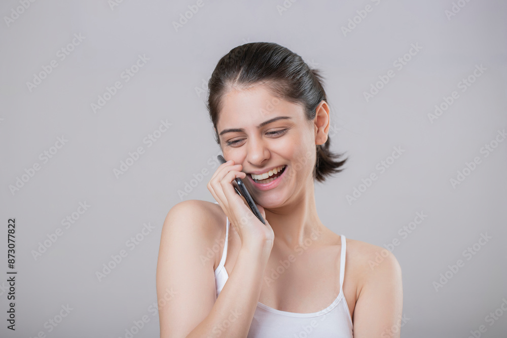 A Glamorous Woman Smiling While Talking On The Phone A Glamorous Woman Smiling While Talking On The Phone