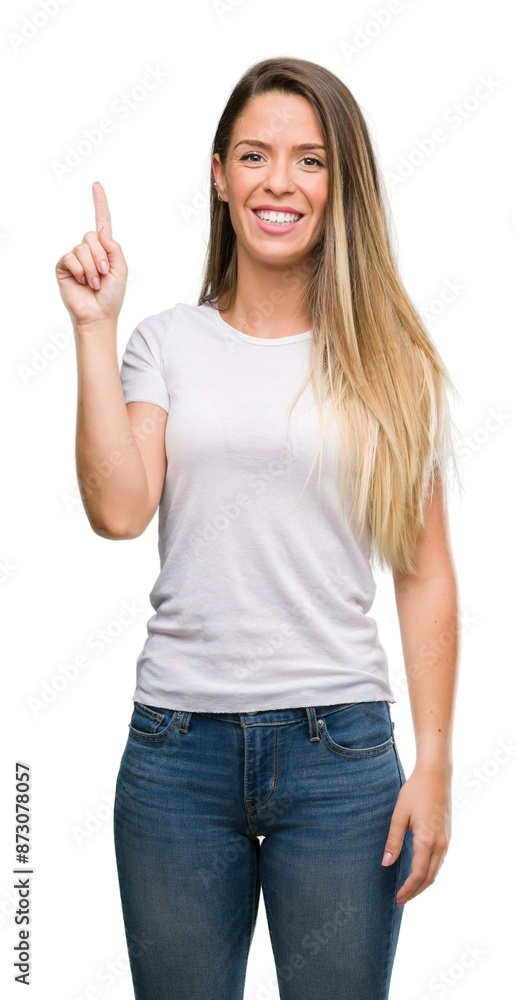 Beautiful young woman wearing t-shirt and jeans surprised with an idea or question pointing finger with happy face, number one Beautiful young woman wearing t-shirt and jeans surprised with an idea or question pointing finger with happy face, number one