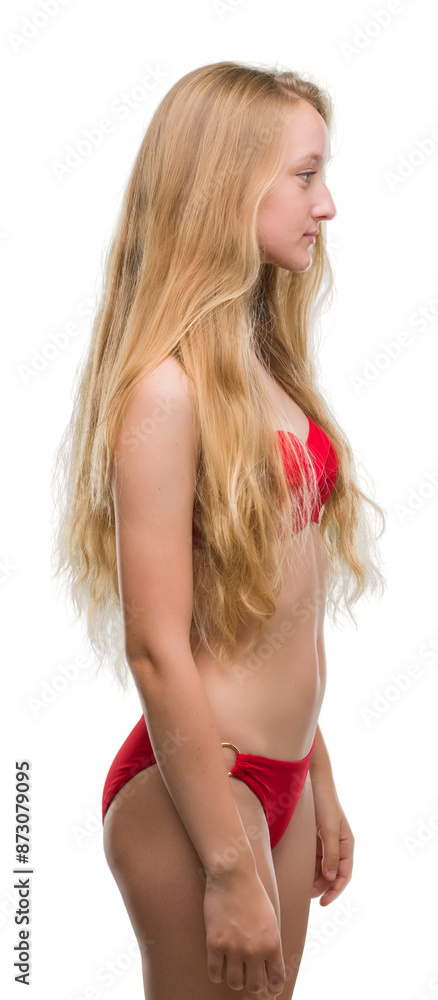 Blonde teenager woman wearing red bikini looking to side, relax profile pose with natural face with confident smile. Blonde teenager woman wearing red bikini looking to side, relax profile pose with natural face with confident smile.
