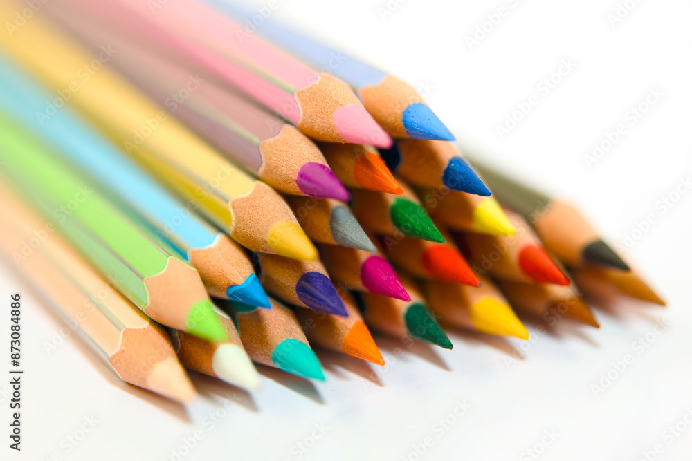 A Stack of Colorful Wooden Pencils Arranged in a Triangular Pattern on a White Background A Stack of Colorful Wooden Pencils Arranged in a Triangular Pattern on a White Background