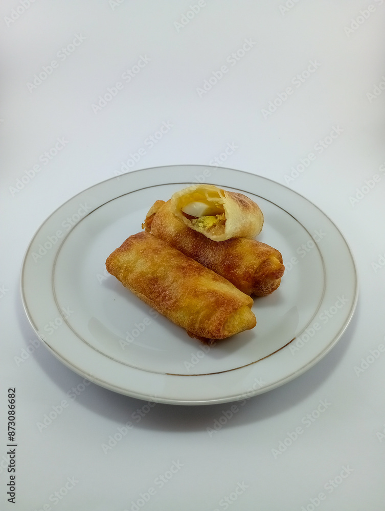 Risoles: Popular Indonesian Snack with Chicken, Carrots, Onion, Potato, and Green Onion Filling, Wrapped in Thin Wrapper, Covered with Bread Crumbs, Deep-Fried on White Background Risoles: Popular Indonesian Snack with Chicken, Carrots, Onion, Potato, and Green Onion Filling, Wrapped in Thin Wrapper, Covered with Bread Crumbs, Deep-Fried on White Background