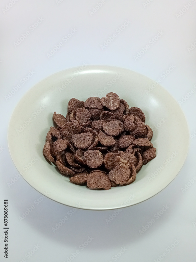 Coco Crunch Cereal in a Small Cream Bowl on White Background: Crunchy and Delicious Breakfast Option, Perfectly Presented for a Simple and Enjoyable Morning Meal Experience Coco Crunch Cereal in a Small Cream Bowl on White Background: Crunchy and Delicious Breakfast Option, Perfectly Presented for a Simple and Enjoyable Morning Meal Experience