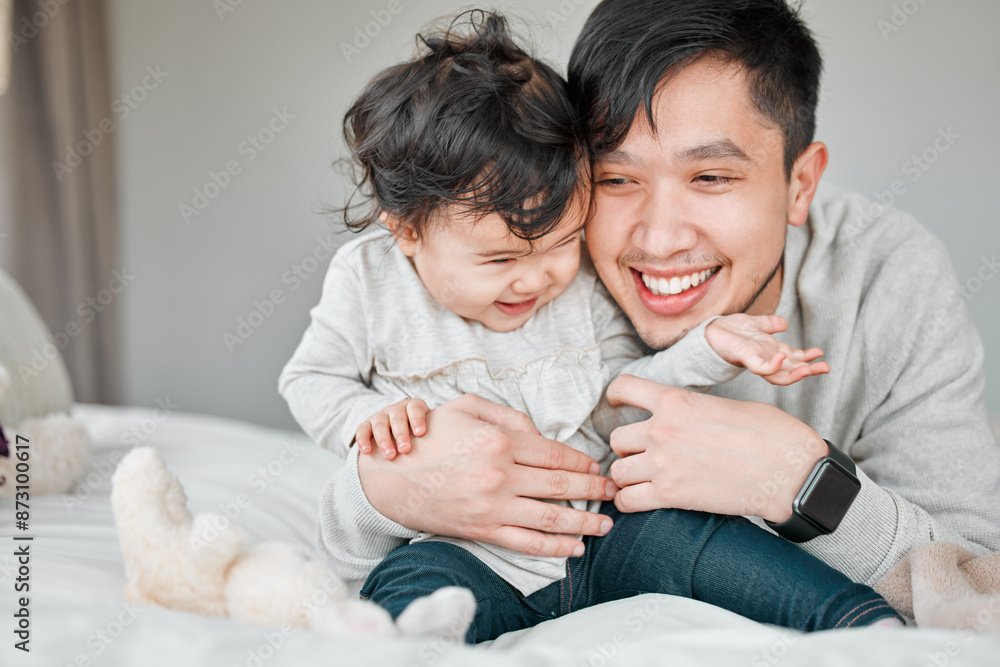 Asian family, father and baby in bed for playful, bonding together and child care with single parent in home. Bedroom, little girl and proud dad for support, security and hug with daughter in house Asian family, father and baby in bed for playful, bonding together and child care with single parent in home. Bedroom, little girl and proud dad for support, security and hug with daughter in house